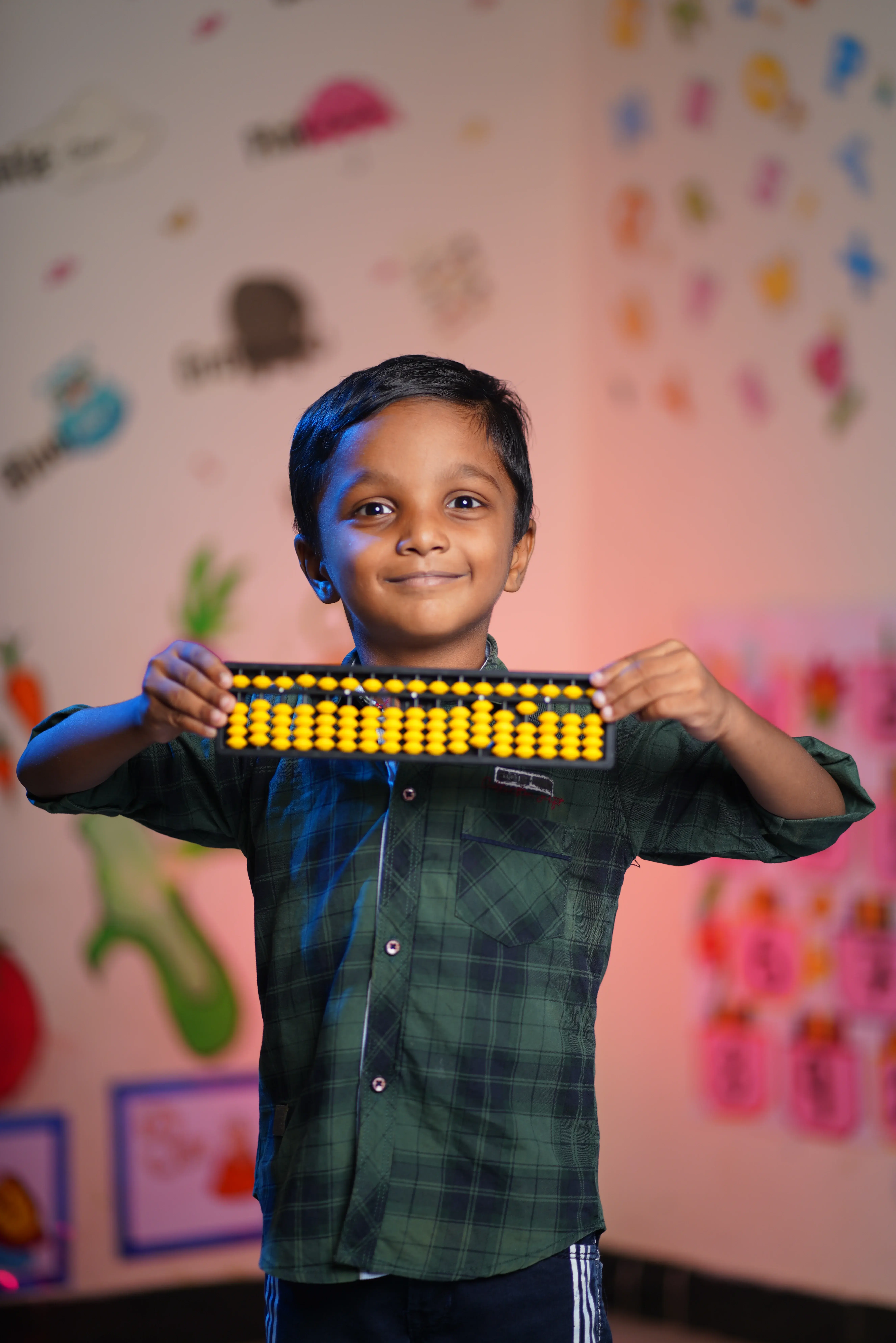 A smiling student with an abacus at her desk